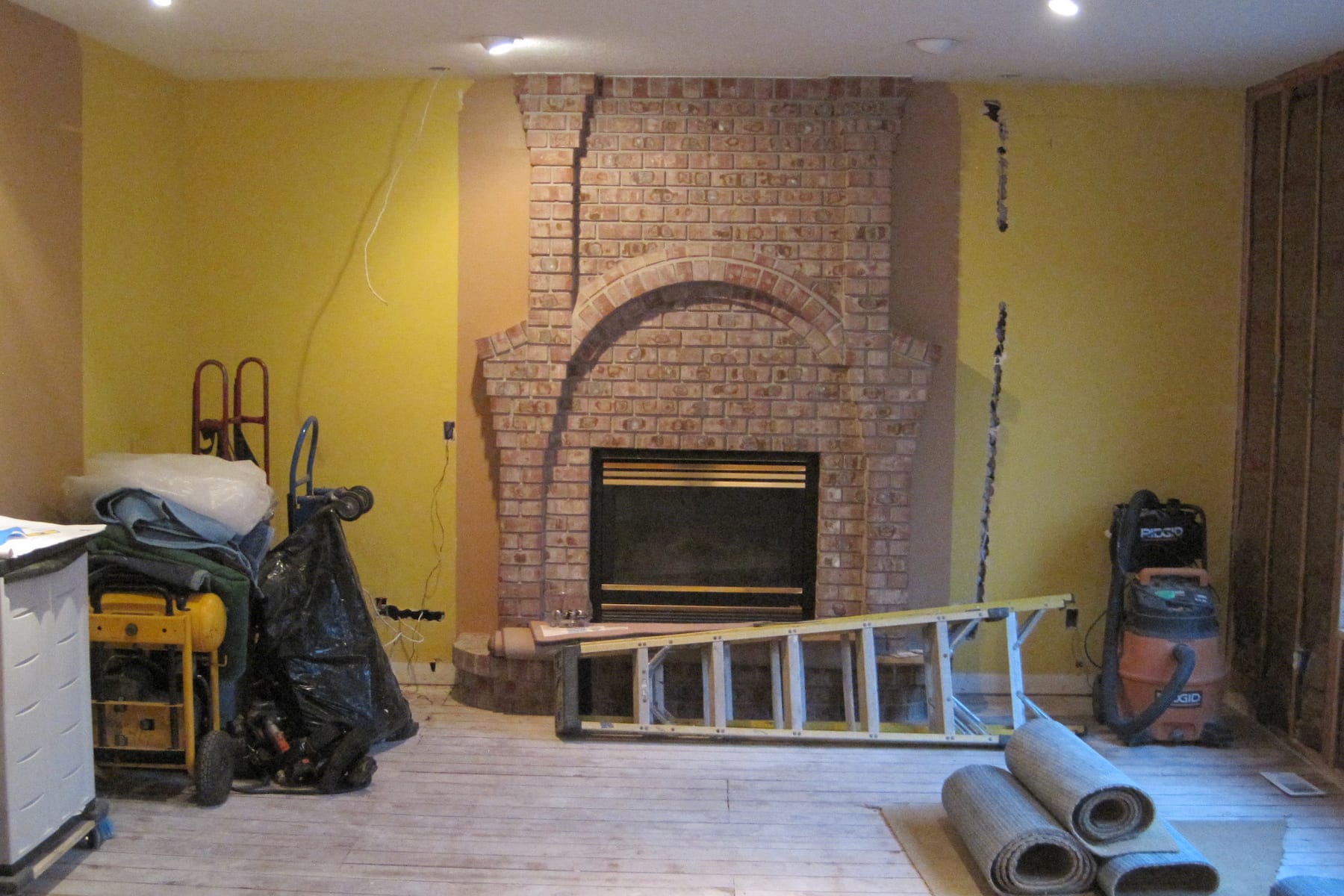 An old fireplace is under construction and being prepped for a remodel