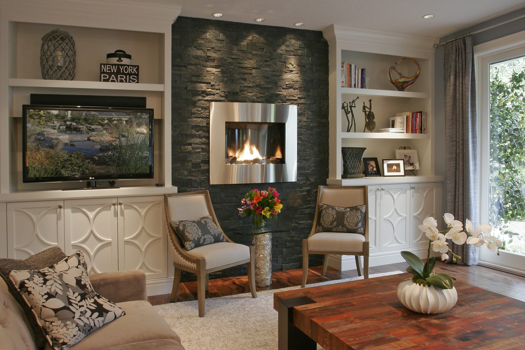 After photo of a fireplace, showcasing the renovated state with updated features and a modern design.