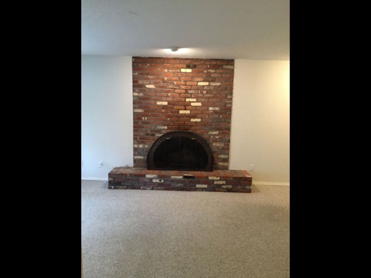 Before photo of the fireplace in the Canal residence, depicting the original state before any updates