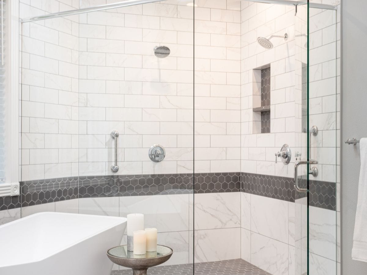 After shot of a gray bathroom shower, revealing a renovated space with modernized fixtures and an enhanced aesthetic appeal