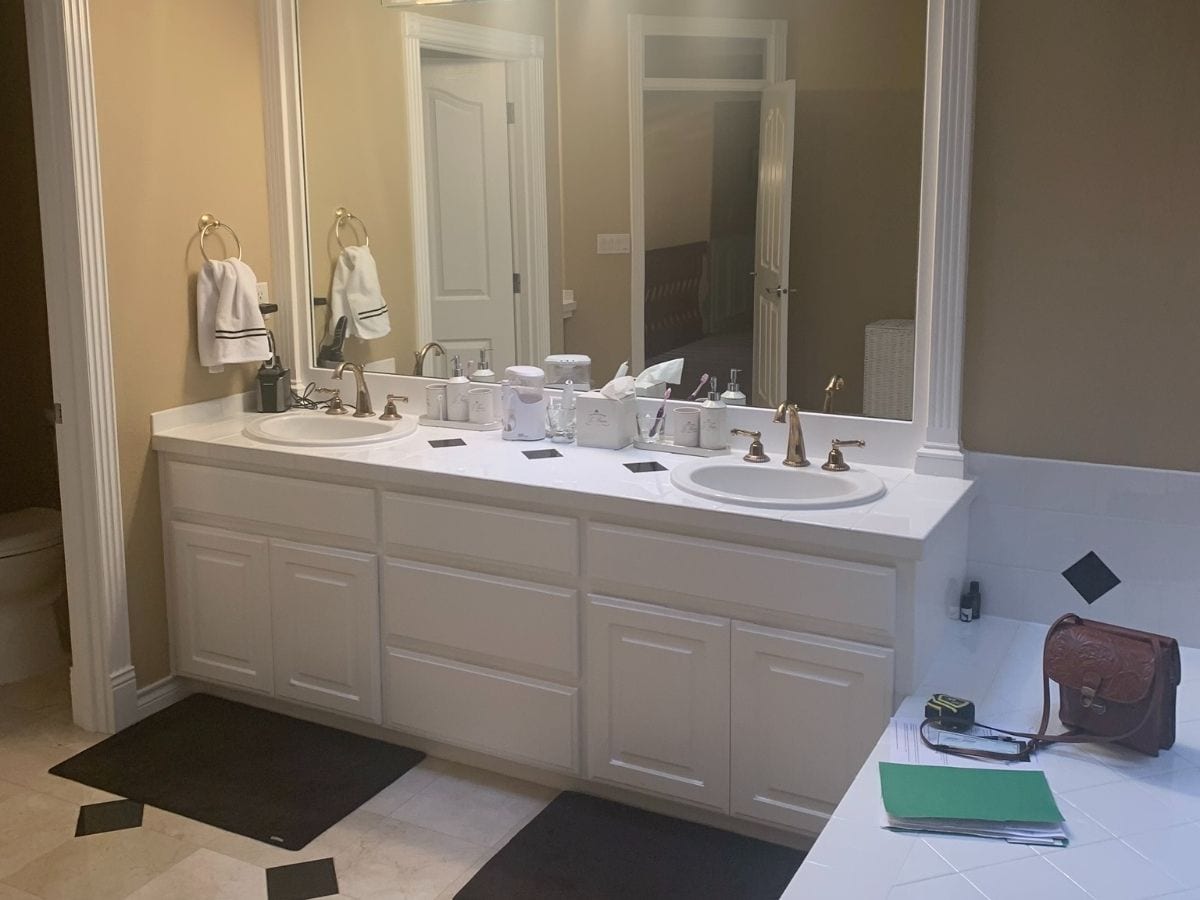 Before photo of a gray bathroom sink, depicting an outdated design in need of modernization and improvements