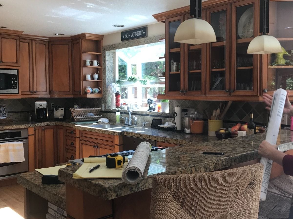 Before photo of a kitchen transformation by Metke Remodeling, featuring outdated elements, worn surfaces, and a dated design in need of renovation