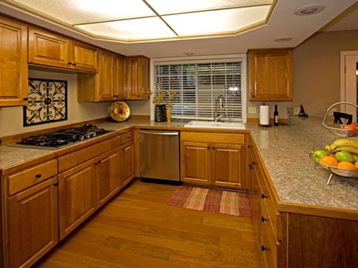 An outdated kitchen with 1980's style decor