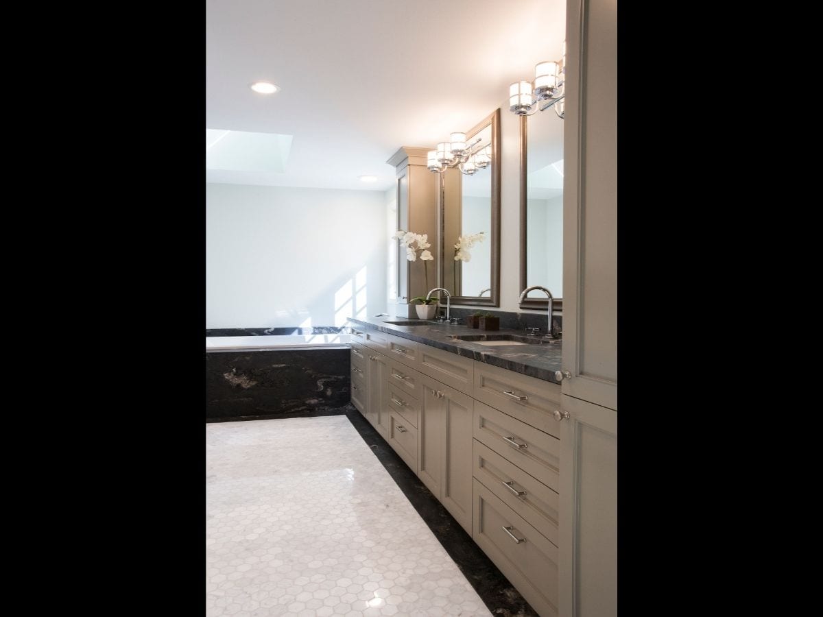 A luxury bath remodel featuring a new vanity and marble bathtub