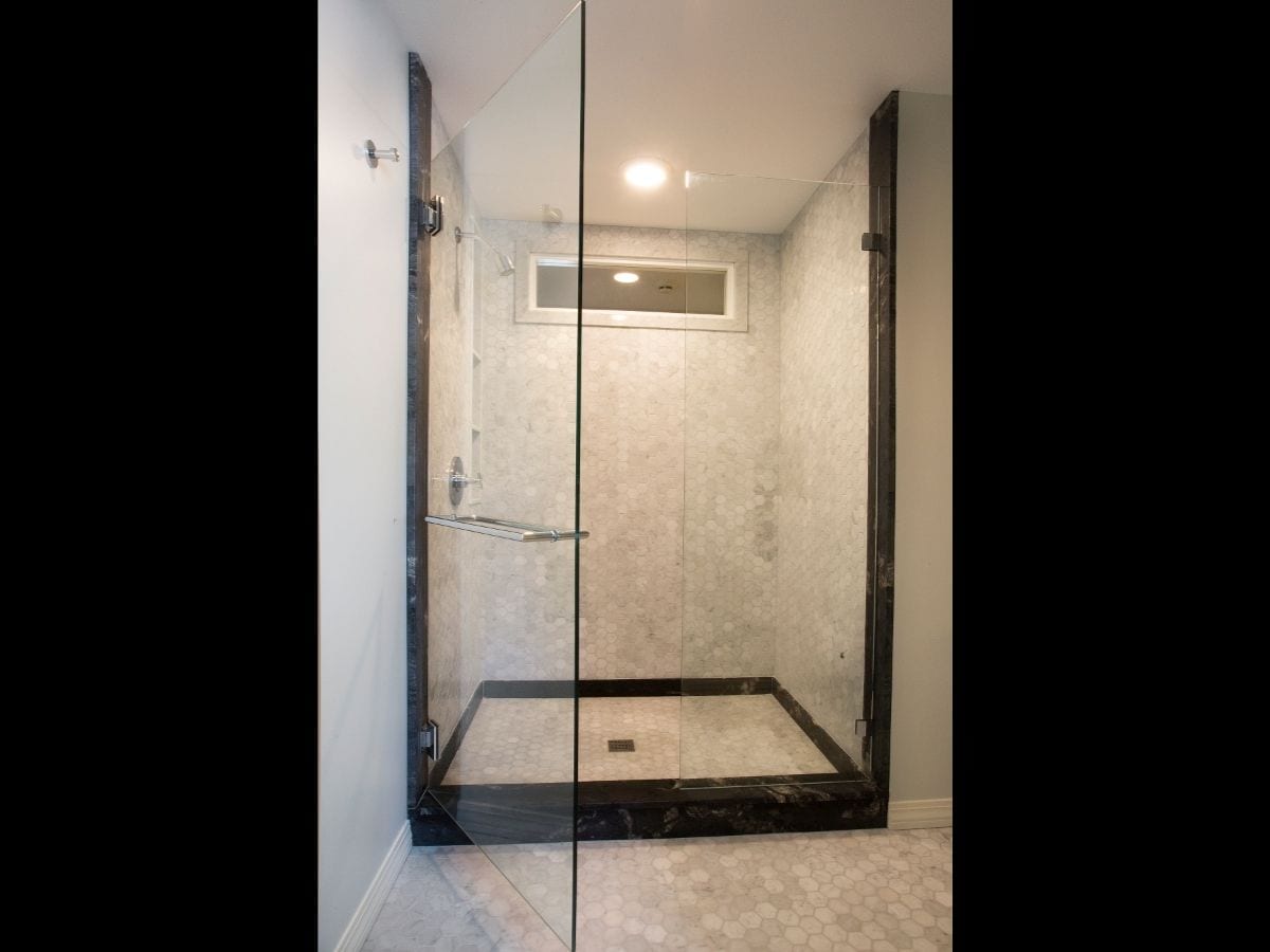 A luxury bathroom shower with glass doors