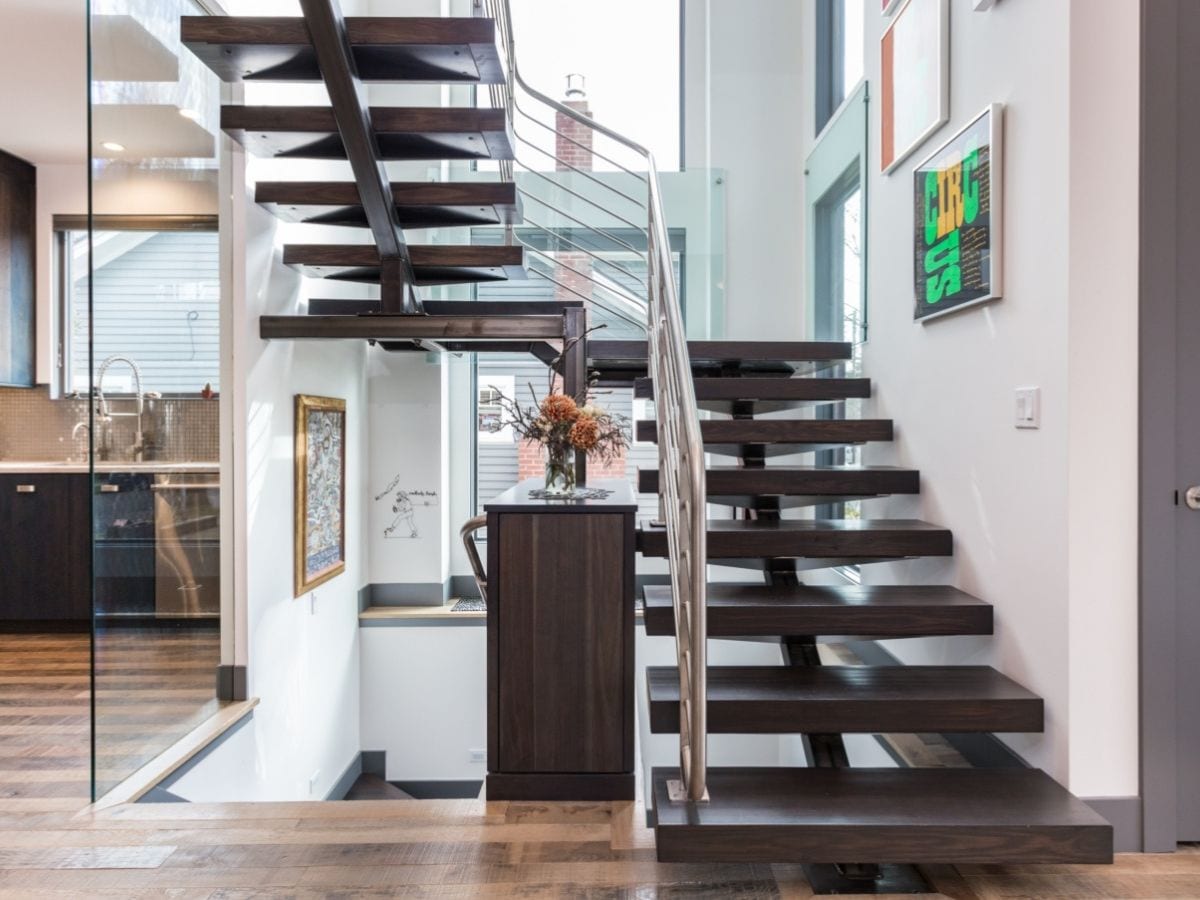 Newly remodeled staircase featuring wooden steps and chrome railing