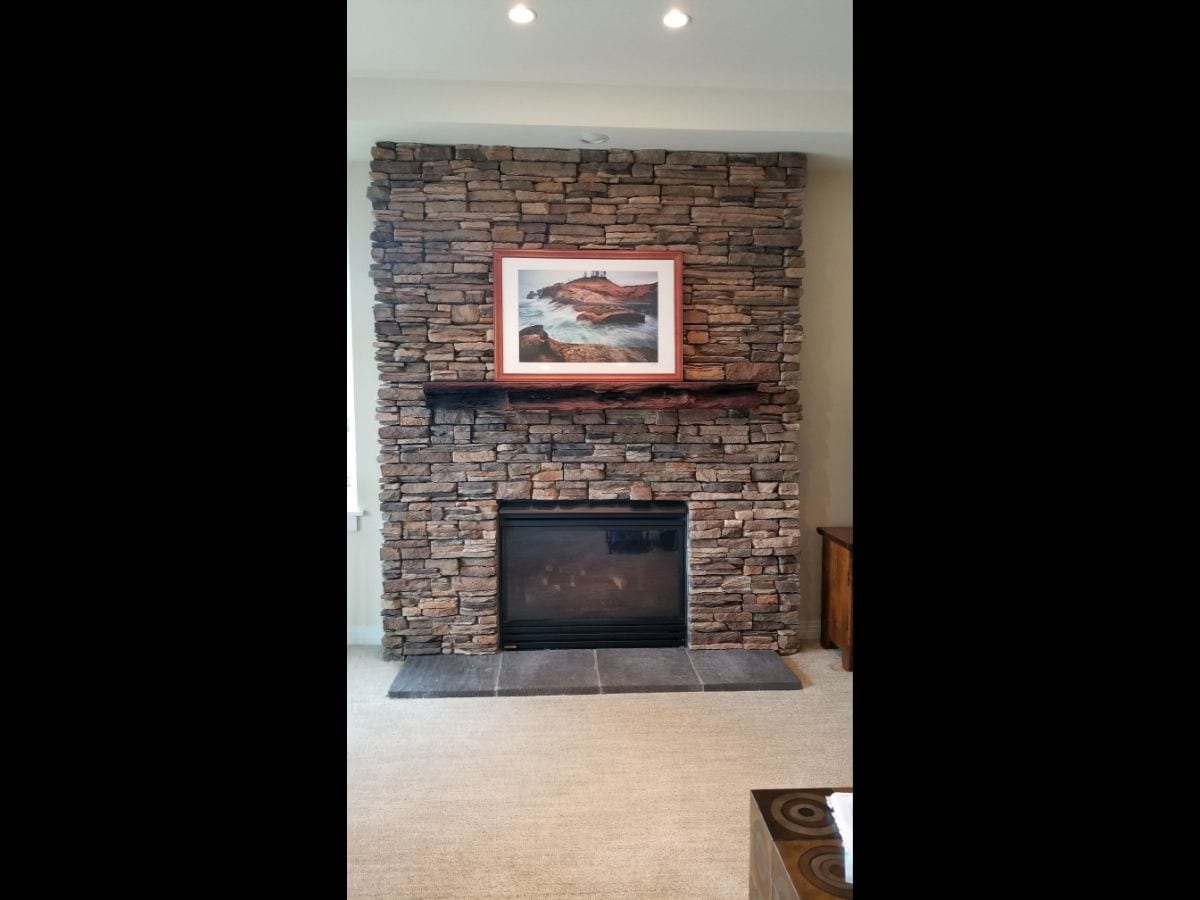 A fireplace area with outdated design elements, dim lighting, and worn-out decor