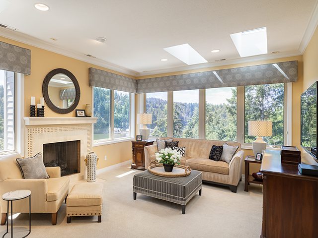 A luxury sitting room with plenty of natural light to help illustrate how to choose paint color.